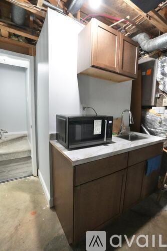 A black microwave oven sitting on a kitchen counter.