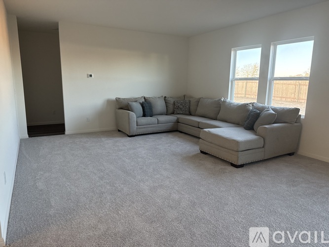 A living room with a grey couch and a grey sofa.
