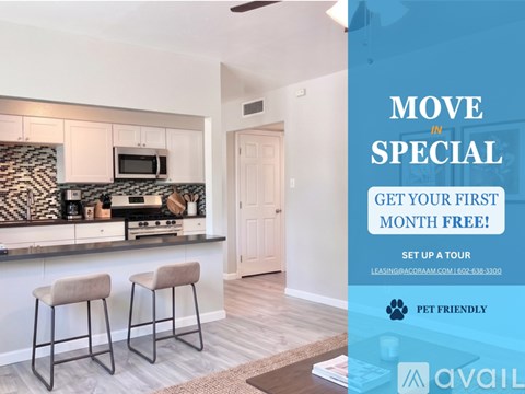 A modern kitchen with a bar stool and a sign offering a free first month.