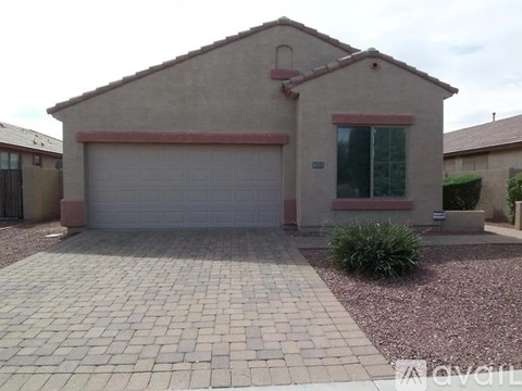 A house with a garage door and a window.