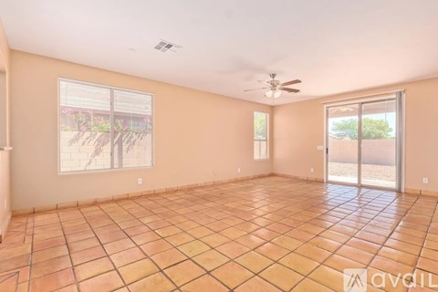 A room with tile flooring and a ceiling fan.