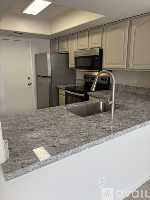 A kitchen with granite countertops and stainless steel appliances.