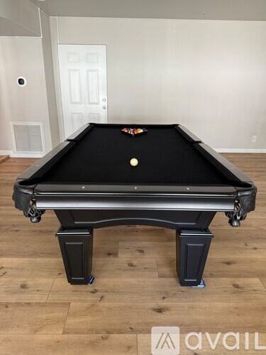 A pool table with a white ball on it.
