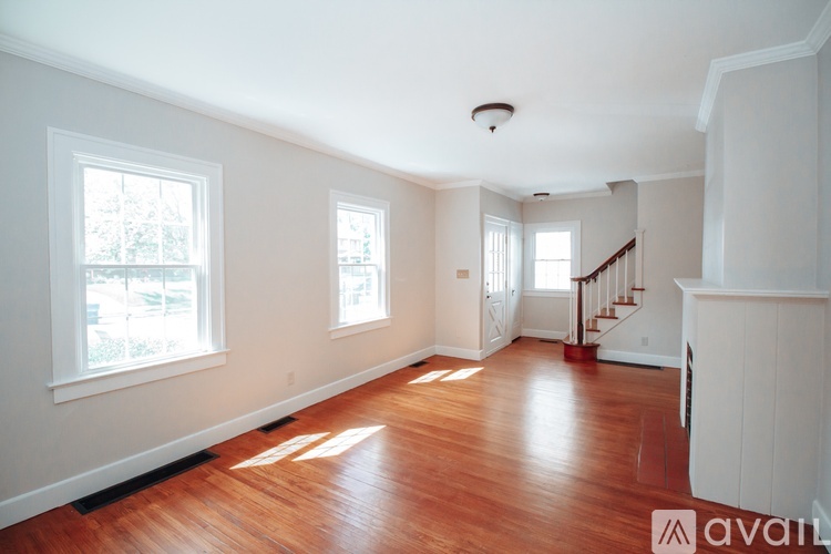 A room with wooden floors and white walls.
