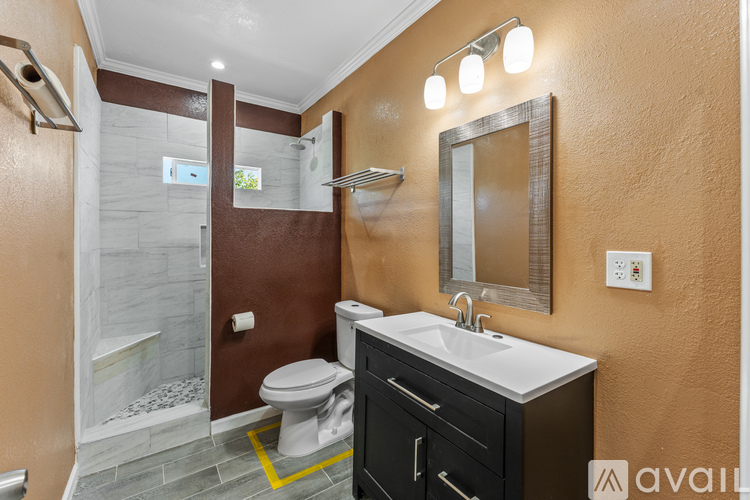 A bathroom with brown walls and a white toilet.