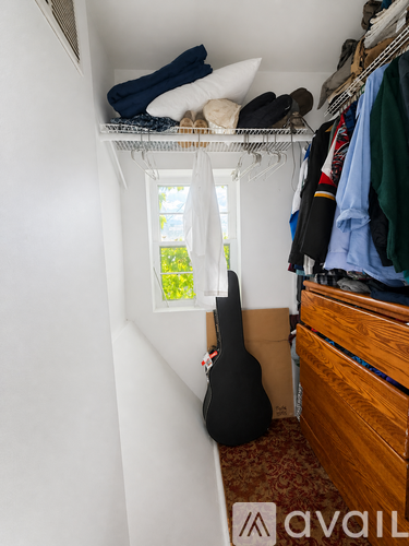A room with a window and a staircase leading to the upper floor.