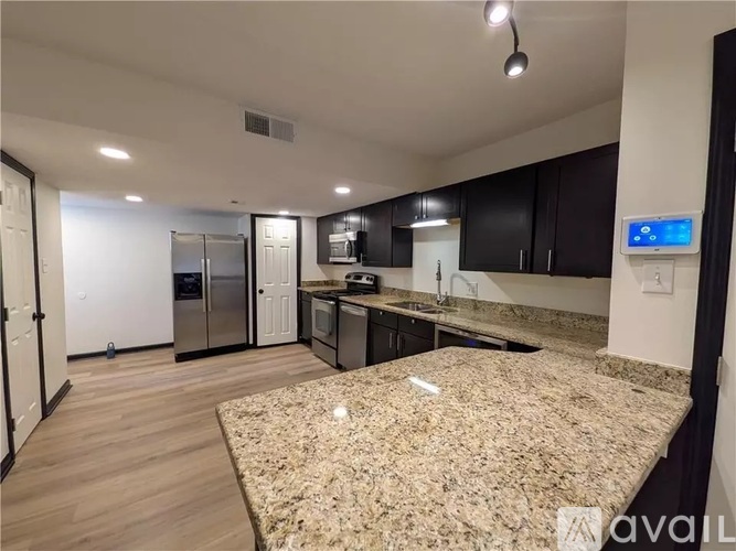 A kitchen with granite countertops and a modern design.
