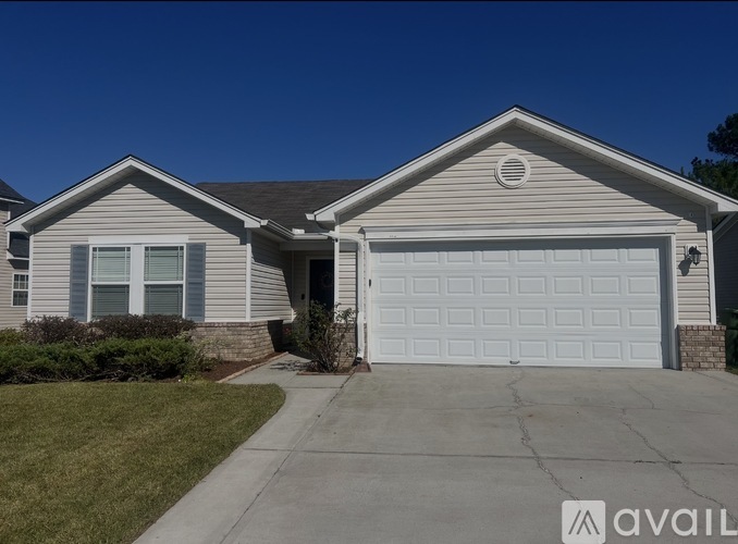 A house with a white garage door and a brown roof.