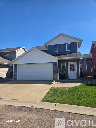A house with a garage is for sale.