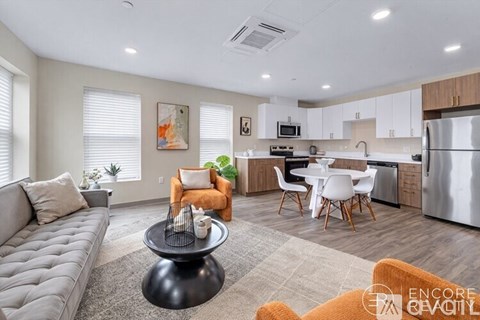 A modern kitchen with a dining table and chairs.