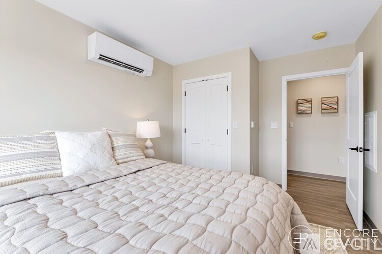 A bedroom with a large bed and a white ceiling fan.