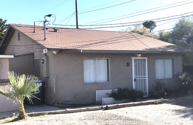 A house with a brown roof and a white door.