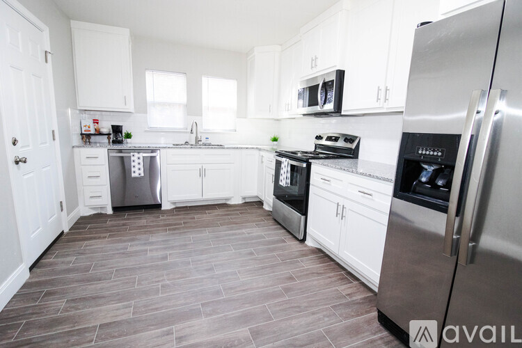 A kitchen with white cabinets and stainless steel appliances.