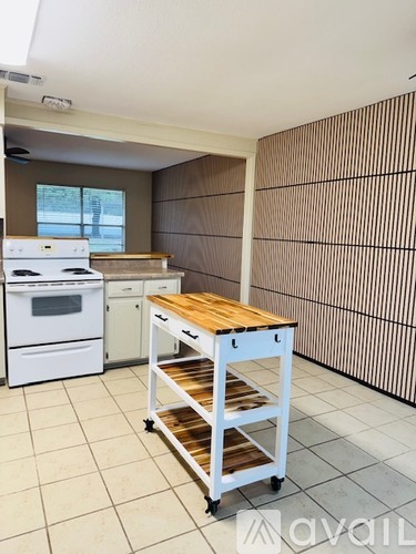A kitchen with a white stove and a white dishwasher.