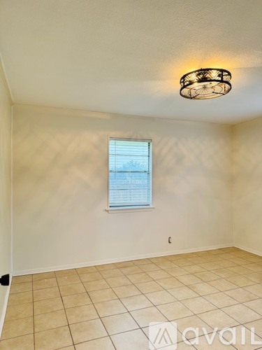A room with a window and a ceiling light.