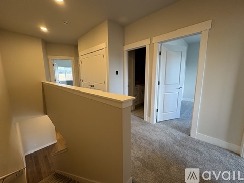 A room with a carpeted floor and a window.