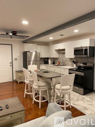 A kitchen with a table and chairs in the middle of the room.