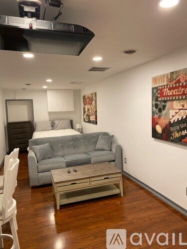A living room with a grey couch and a coffee table.