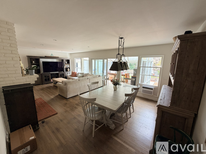 A living room with a dining table and chairs.