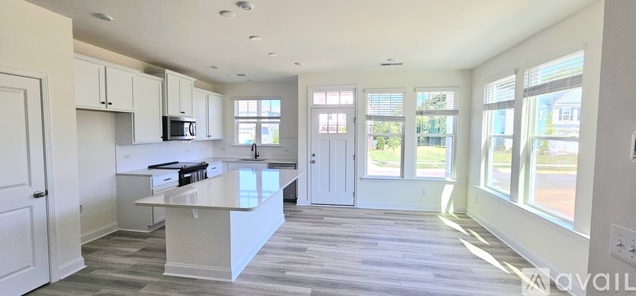 A spacious kitchen with a large island in the middle.