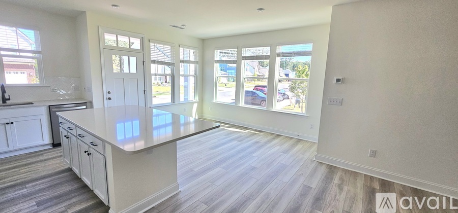 A spacious kitchen with white cabinets and a large island.