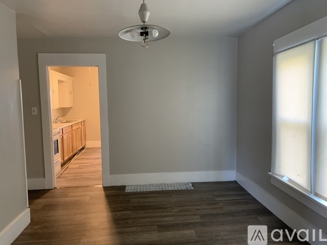 A room with a wooden floor and a ceiling fan.