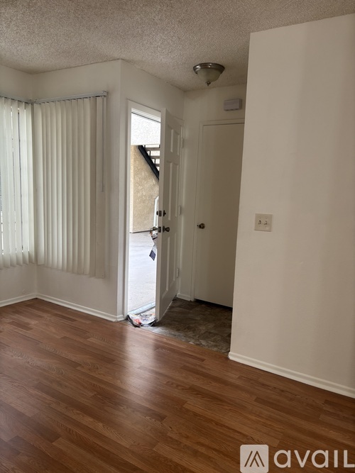 A room with wooden floors and a white door.