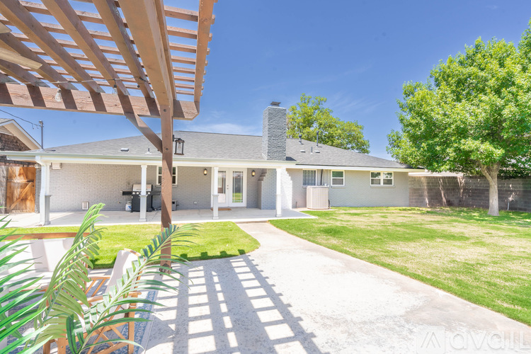 A house with a white exterior and a green lawn.