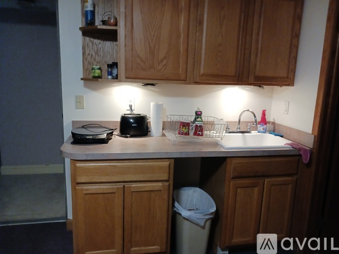A kitchen with wooden cabinets and a white countertop.