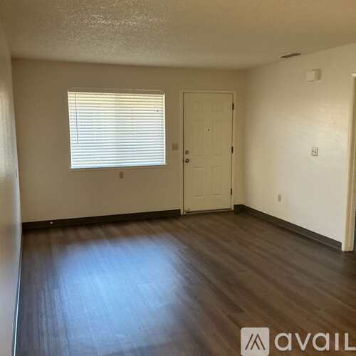 A room with wooden floors and a white door.