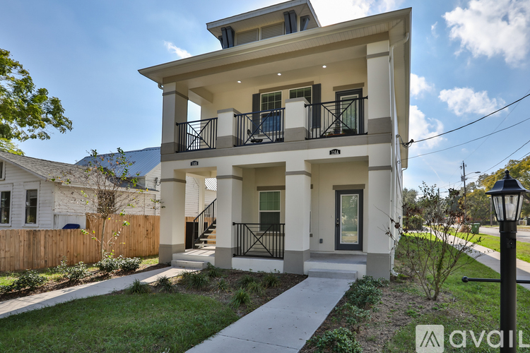 A two-story house with a balcony on the second floor.
