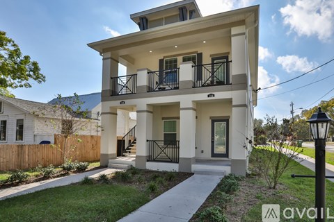A two-story house with a balcony on the second floor.