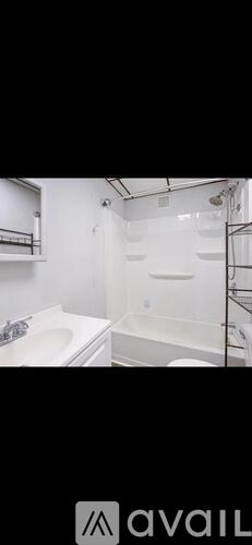 A bathroom with a white sink and bathtub.