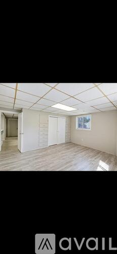A room with a white ceiling and wooden flooring.