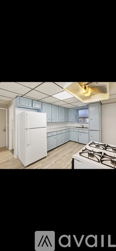 A kitchen with a white refrigerator and a stove top oven.