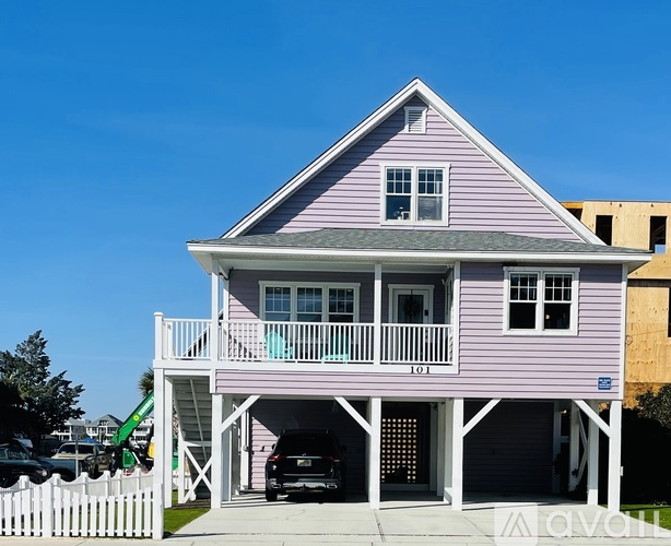 A two-story house with a balcony and a garage.