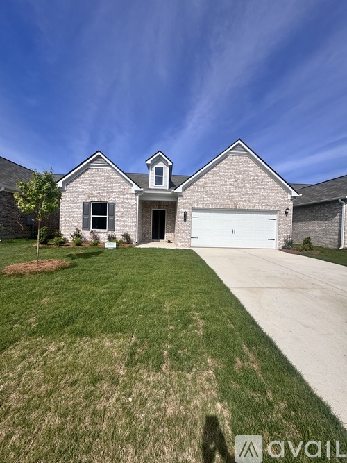 A house with a garage and a driveway in front.