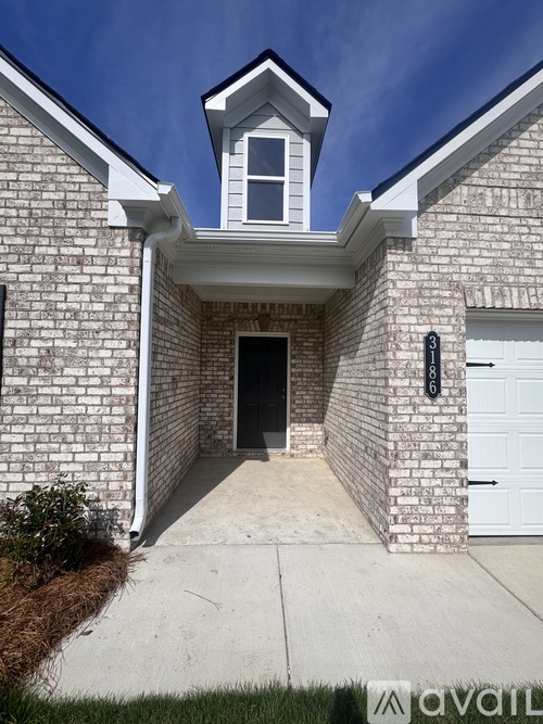 A house with a white door and a window above the door.