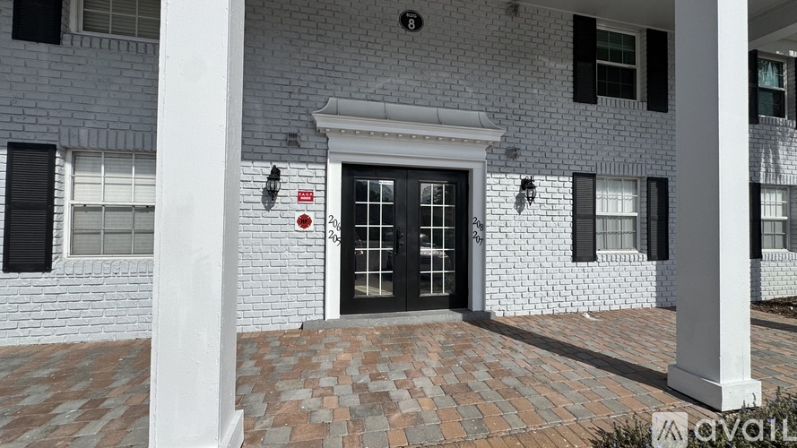A white house with a black door and windows.