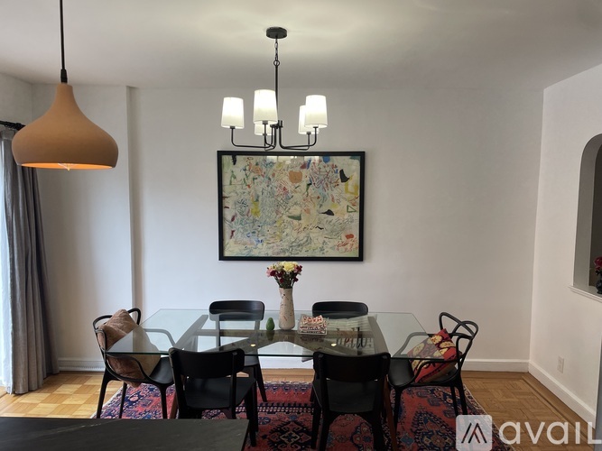 A dining room with a glass table and chairs.