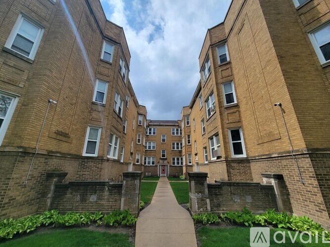 A brick building with a walkway in front.