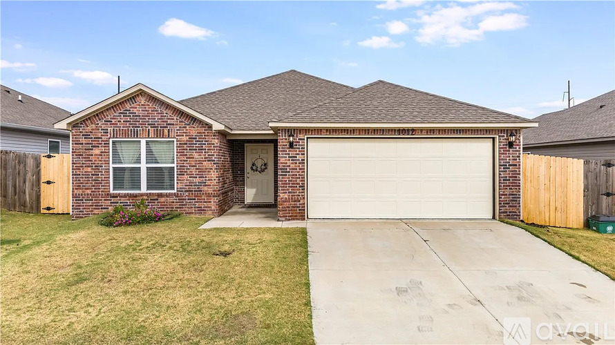 A house with a brown brick exterior and a white garage door.