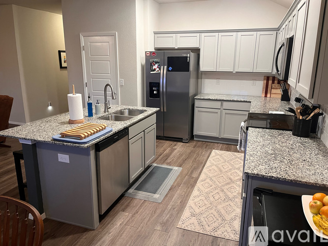 A kitchen with granite countertops and stainless steel appliances.