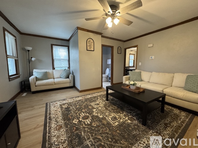 A living room with a rug, a couch, and a coffee table.