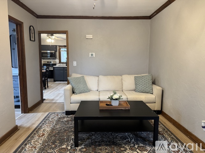 A living room with a white couch and a coffee table.