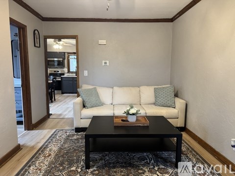 A living room with a white couch and a coffee table.
