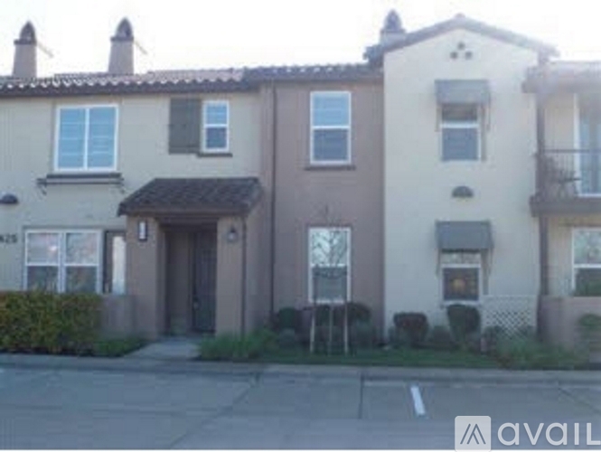 A row of townhouses with a sign that says "AVAILABLE" in front of them.