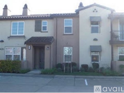 A row of townhouses with a sign that says "AVAILABLE" in front of them.