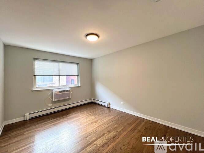 A room with a window and a fan on the floor.