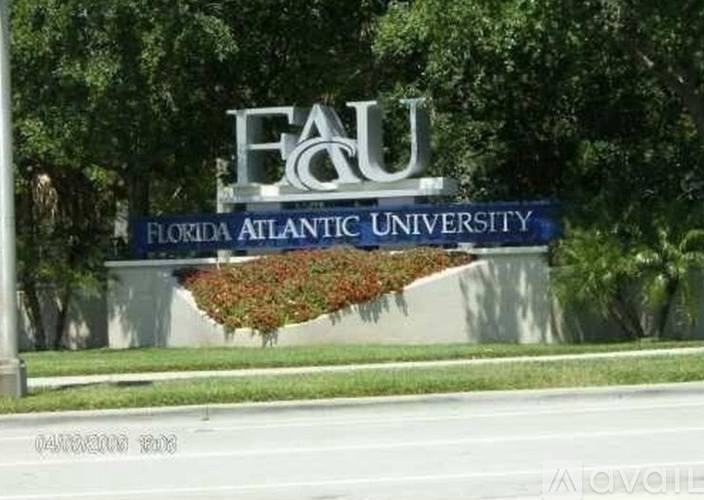 Florida Atlantic University sign in front of trees.
